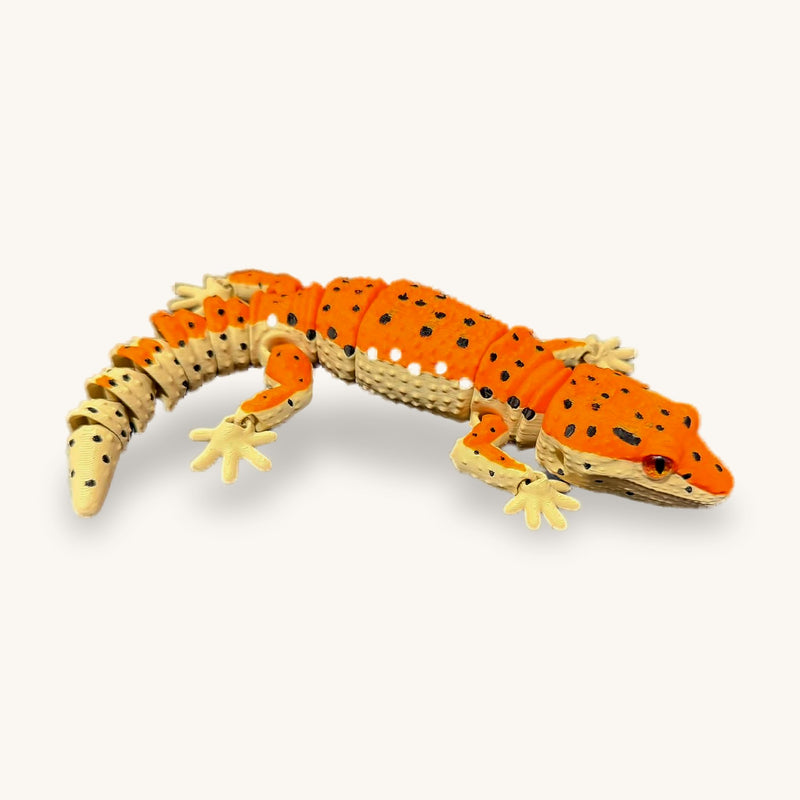 3D-printed articulated leopard gecko, orange with black spots and a banded tail