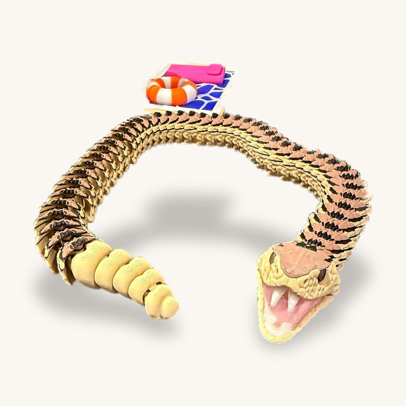 3D-printed articulated rattlesnake in a curve, mouth open, segmented rattle on the tail
