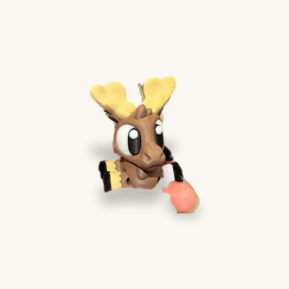 Small 3D-printed moose with pale antlers and jointed legs, held in a hand